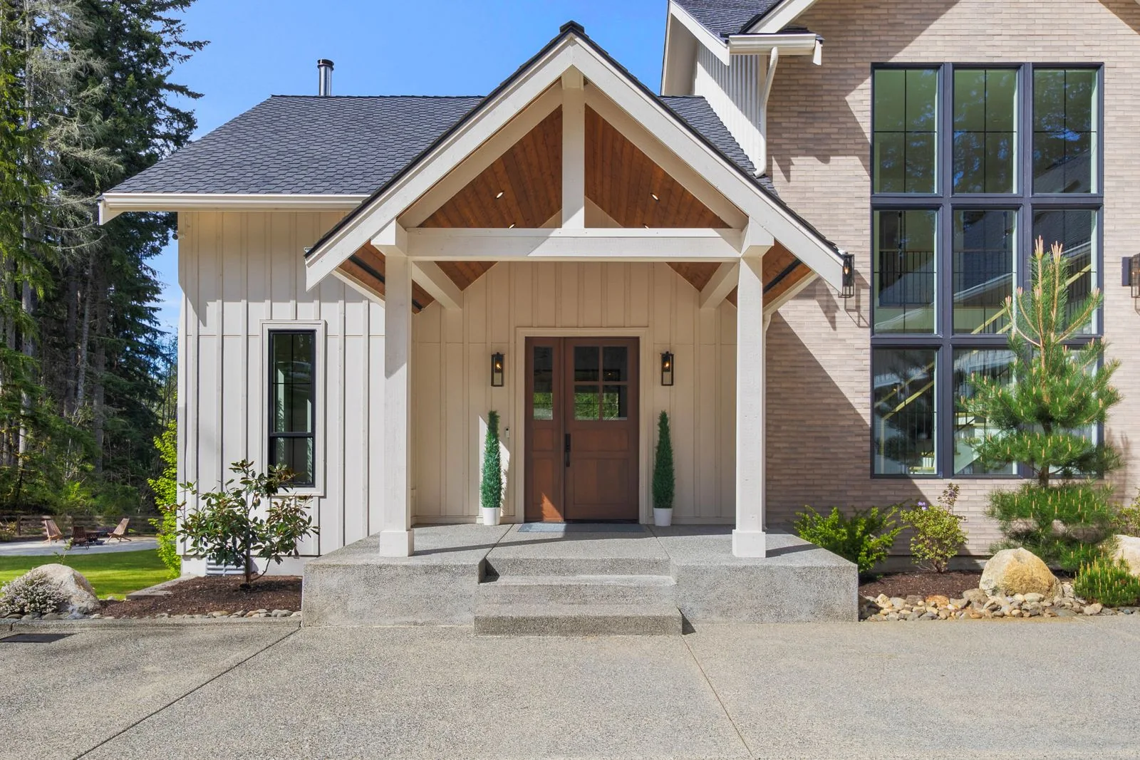 Daylight exterior with a timber-framed entry and landscaped approach