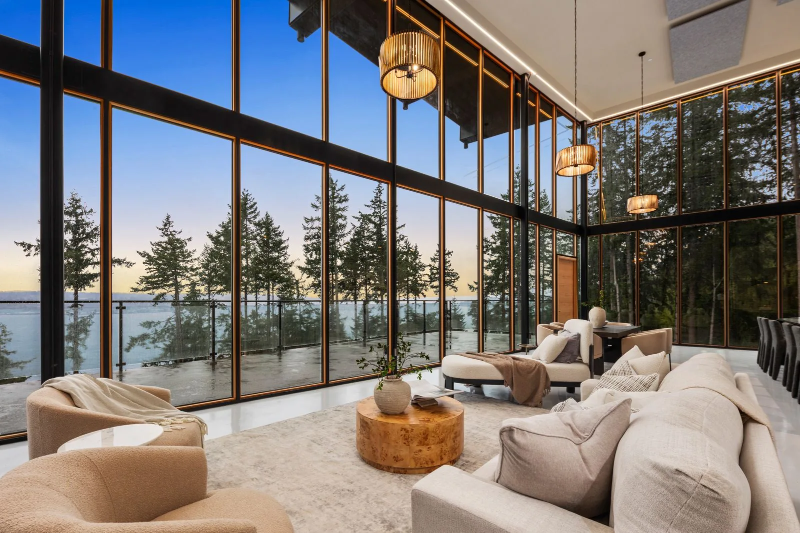 Double-height living room with floor-to-ceiling windows and water views